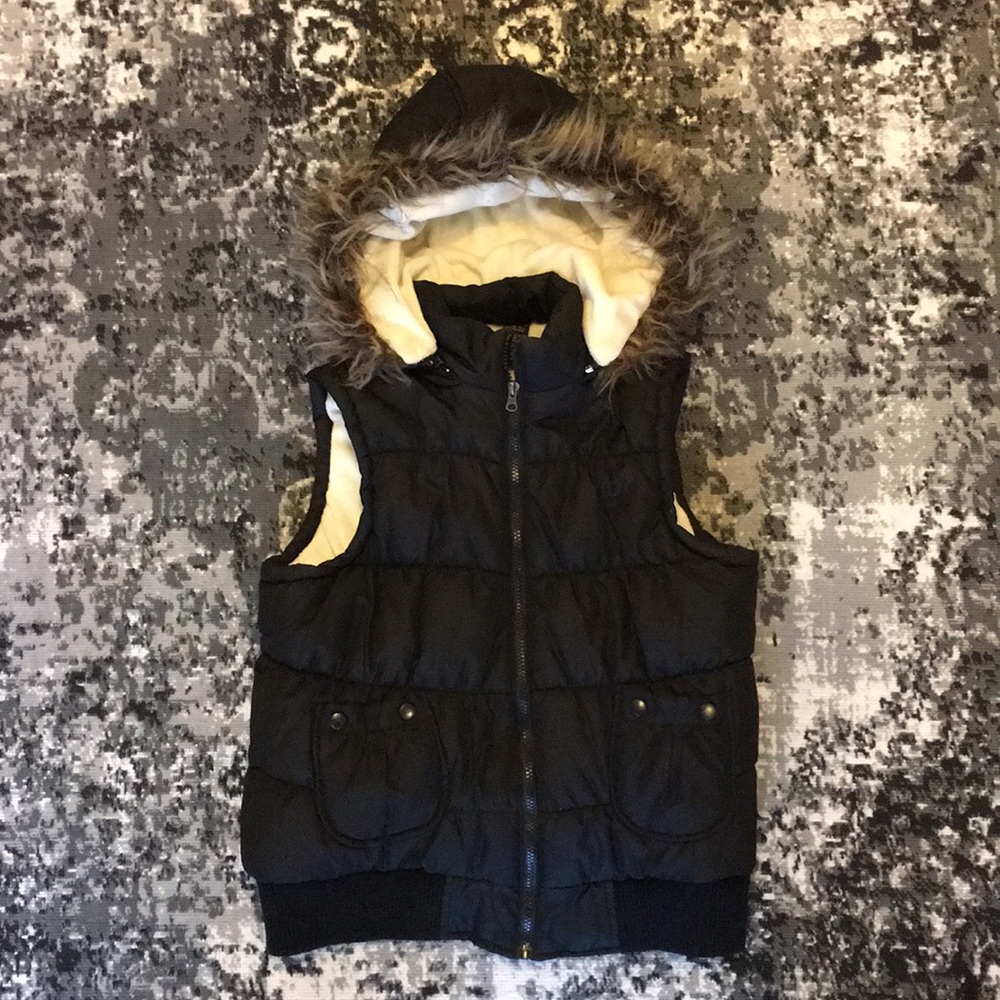 Black down vest with fur hoodie.
